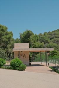 a pavilion in a park with trees in the background at Hotel Santa Marta in Lloret de Mar