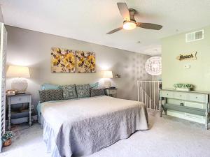 a bedroom with a bed and a ceiling fan at Stunning Tree Tops Apt - Disney! in Kissimmee