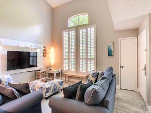 a living room with two couches and a tv at Stunning Tree Tops Apt - Disney! in Kissimmee