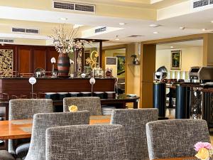 a dining room with chairs and a table at Arion Suites Hotel Kemang in Jakarta
