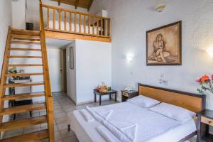 a bedroom with a bunk bed and a ladder at Creta Aquamarine Hotel in Platanes