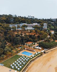an aerial view of a resort with a swimming pool and a beach at Hotel Santa Marta in Lloret de Mar