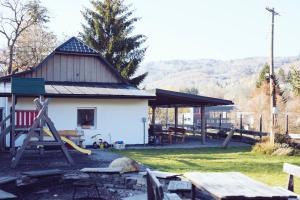 a building with a picnic table and a playground at Chalúpka na konci in Banská Štiavnica