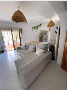 a living room with a gray couch in a room at Apartamento Vista Praia e Mar- Costa da Caparica in Costa da Caparica