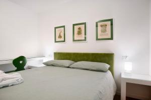 a bedroom with a bed and three pictures on the wall at La casa di Marco in Cavalese