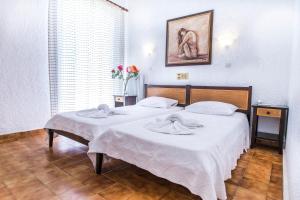 A bed or beds in a room at Creta Aquamarine Hotel