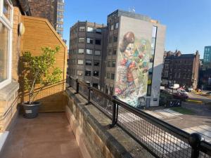 a mural of a woman on the side of a building at Stylish city-centre apartment with balcony in Liverpool