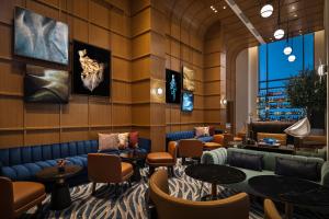 a lobby of a hotel with couches and tables at Vida Creek Beach Hotel in Dubai