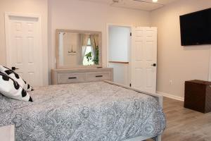 a bedroom with a bed and a large mirror at Modern 1BR Exclusive Space in Historic Brooklyn in Brooklyn