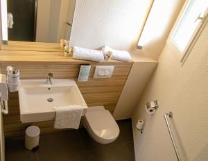 a small bathroom with a sink and a toilet at Campanile Toulouse - Blagnac Aéroport in Blagnac