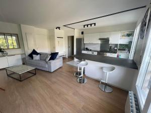 a living room with a couch and a table at Disney appartement in Chessy +7 photos