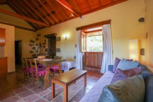 a living room with a couch and a table at Countryside Views House Teror in Teror