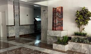 a lobby with plants and a painting on the wall at MY ALVA PARK - 50m from the beach in Lloret de Mar +21 photos