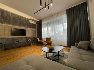 a living room with a couch and a table at Elite Central Suites in Skopje