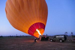 a hot air balloon with a jeep in a field at Riad Layla Rouge in Marrakesh