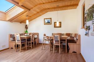 a dining room with wooden tables and chairs at Mongaduierhof Apt Panorama in Umes