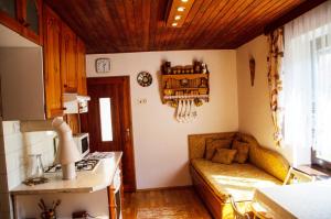 a kitchen with a couch in the corner of a room at Ubytovanie u Eriky in Hrabušice