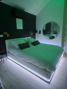 a bedroom with a large bed with a large mirror at Suite romantique avec Spa et filet suspendu in Auteuil