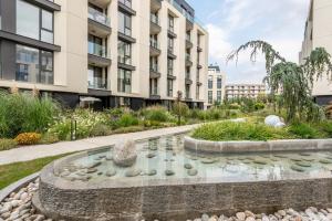 a garden with a fountain in front of a building at Apartment A - Lifestyle Holiday in St. St. Constantine and Helena