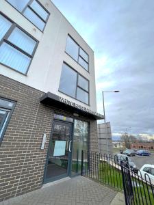 a white brick building with a sign that reads white house research at Home Crowd Luxury Apartments - White Rose Apartments in Doncaster