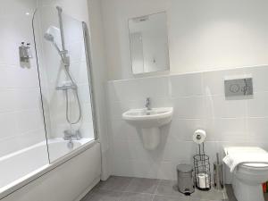 a bathroom with a shower sink and a toilet at Home Crowd Luxury Apartments - White Rose Apartments in Doncaster