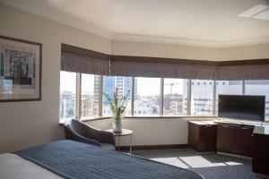 a bedroom with a bed and a large window at Kaya Prestige in İzmir