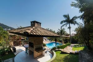 a resort with a fireplace and a swimming pool at Pousada Albacora in Bombinhas