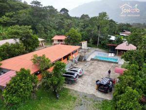an aerial view of a house with cars parked in front of it at SONCCO LODGE in Quillabamba
