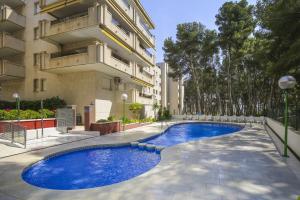 a swimming pool in front of a building at New Uolas Planet Costa Dorada in Salou