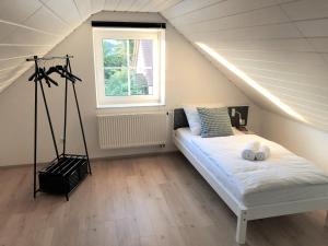 a bedroom with a bed in a attic with a window at Apartment-Regner in Weidenberg
