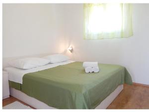 Postel nebo postele na pokoji v ubytování Apartments Nedjeljka