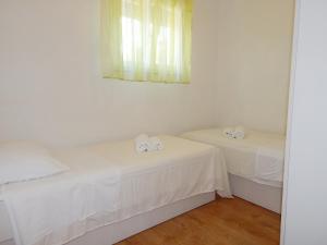 Postel nebo postele na pokoji v ubytování Apartments Nedjeljka