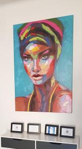 a painting of a woman with a turban at Charmante Zentrumswohnung mit Balkon und 80 zoll TV in Klagenfurt