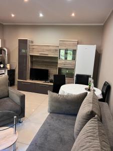 a living room with a couch and a table at Look of Dreams - Apartament Milowice in Sosnowiec