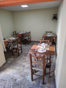 a dining room with wooden tables and chairs at Pousada la colline in Santo Antônio do Pinhal
