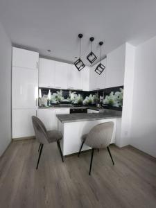 a kitchen with two chairs and a counter in a room at Modern apartment. Best location in Sofia