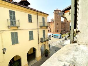 an apartment building with a balcony and a street at LE TORRI Loft Apartment in Fossano