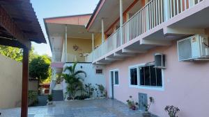 a house with a staircase and a courtyard at HOTEL ALAMEDA in Cuiabá