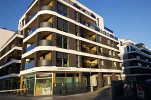 an apartment building with balconies on the side of it at Apartament BOTANIQ #free parking in Bydgoszcz
