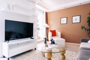 a living room with a large flat screen tv at Chic Flat w Closed Balcony 10 min to Bebek Shore in Istanbul