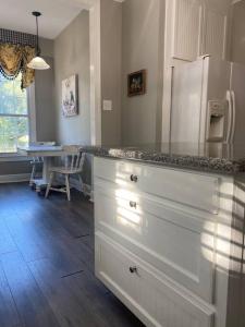 a kitchen with a white refrigerator and a table at Quiet & Beautiful Country Home in Baker