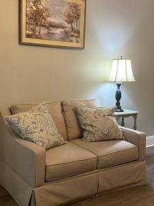 a couch in a living room with a lamp at Quiet & Beautiful Country Home in Baker