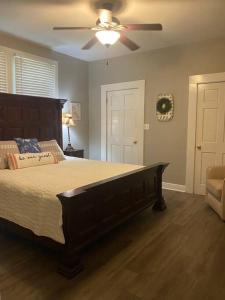 a bedroom with a large bed and a ceiling fan at Quiet & Beautiful Country Home in Baker