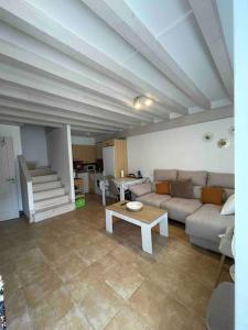 a living room with a couch and a table at Casa en la montaña con piscina de temporada in Arredondo