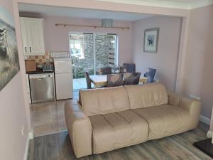 a living room with a couch and a kitchen at 3 Riverwalk, Wicklow Town in Wicklow