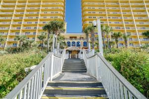 a staircase leading to a resort with two tall buildings at Calypso Resort by Panhandle Getaways in Panama City Beach