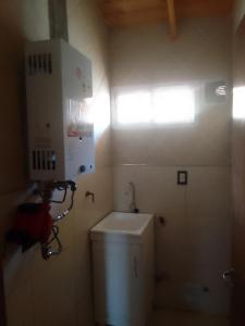 a small bathroom with a toilet and a window at Duplex Dorrego- Guaymallén in Guaymallen