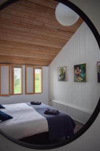 a bedroom with a large bed with a round mirror at Hótel Skálholt in Skálholt