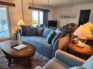 a living room with a couch and a table at Hacienda del Sol II - 404 in New Smyrna Beach