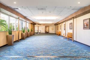 an empty hallway in a building with windows and blue carpet at MGM Signature Towers by FantasticStay in Las Vegas